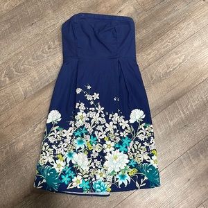 Navy short strapless dress with floral design.